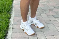 A front view of a person wearing the Reebok Women's Nano Court Shoes