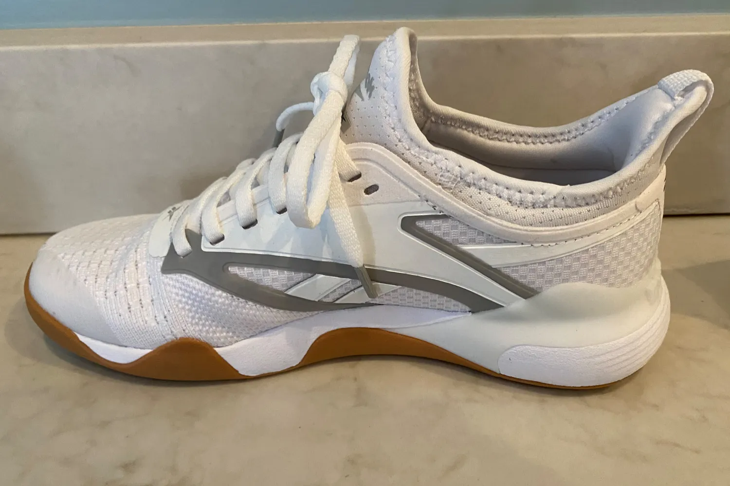 A Reebok Women's Nano Court Shoe on a countertop