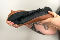 Person holding Relxfeet Men's Barefoot Shoes Minimalist Cross