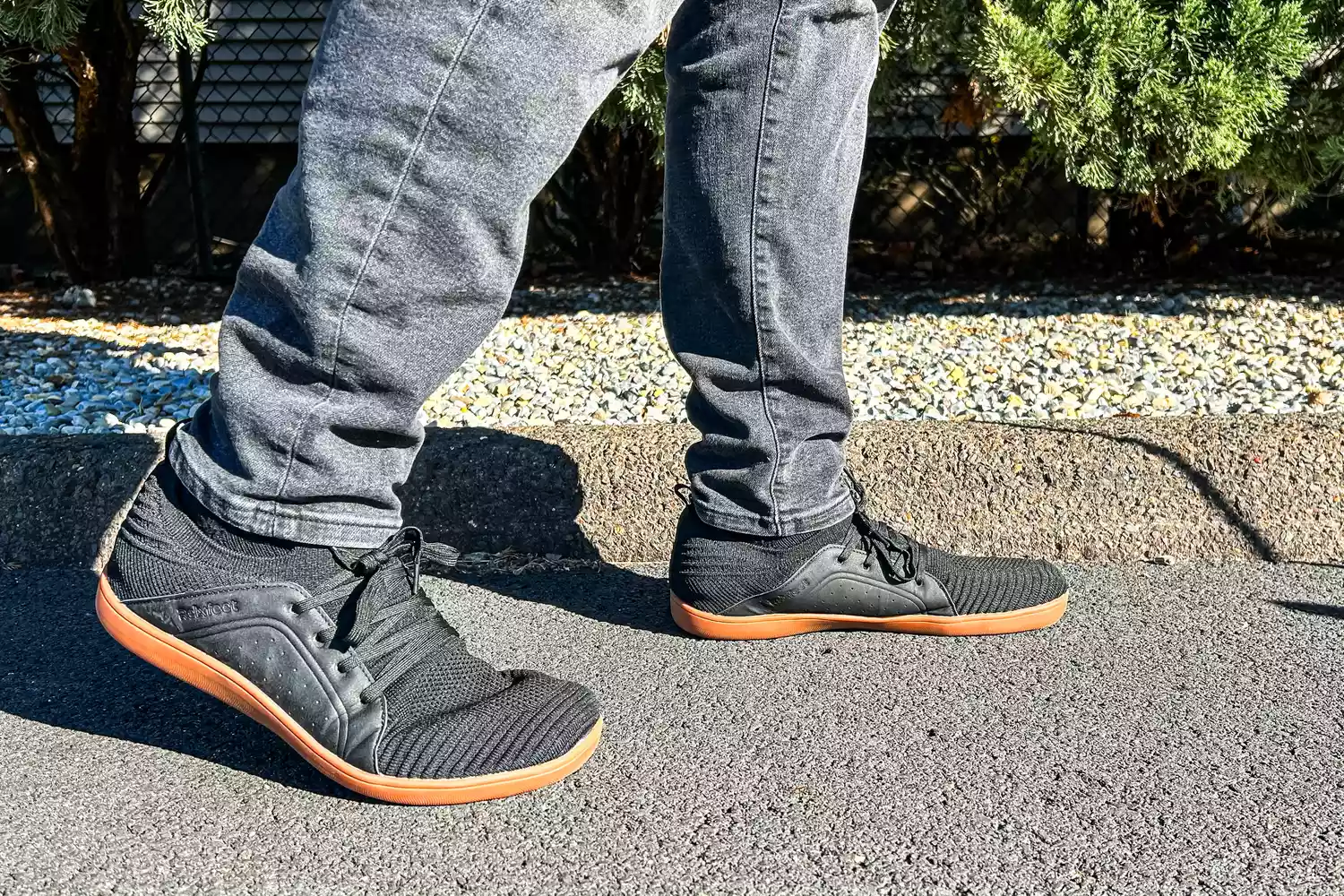 A person walks outside while wearing the Relxfeet Men's Minimalist Barefoot Shoes