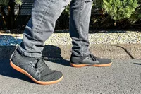 A person walks outside while wearing the Relxfeet Men's Minimalist Barefoot Shoes