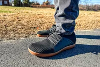 A person walks outside while wearing the Relxfeet Men's Minimalist Barefoot Shoes