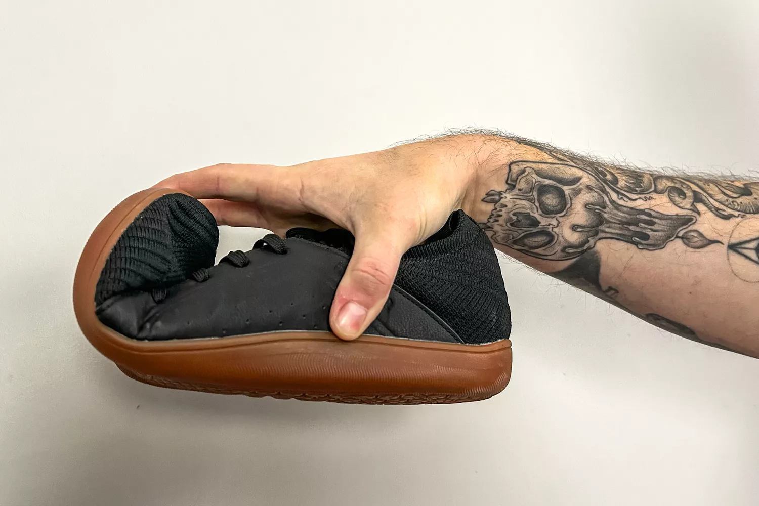 A person bends the toe of the Relxfeet Men's Minimalist Barefoot Shoe