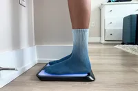 A side view of a person standing on the Renpho R-MSB02 Elis Chroma Aspire Smart Scale