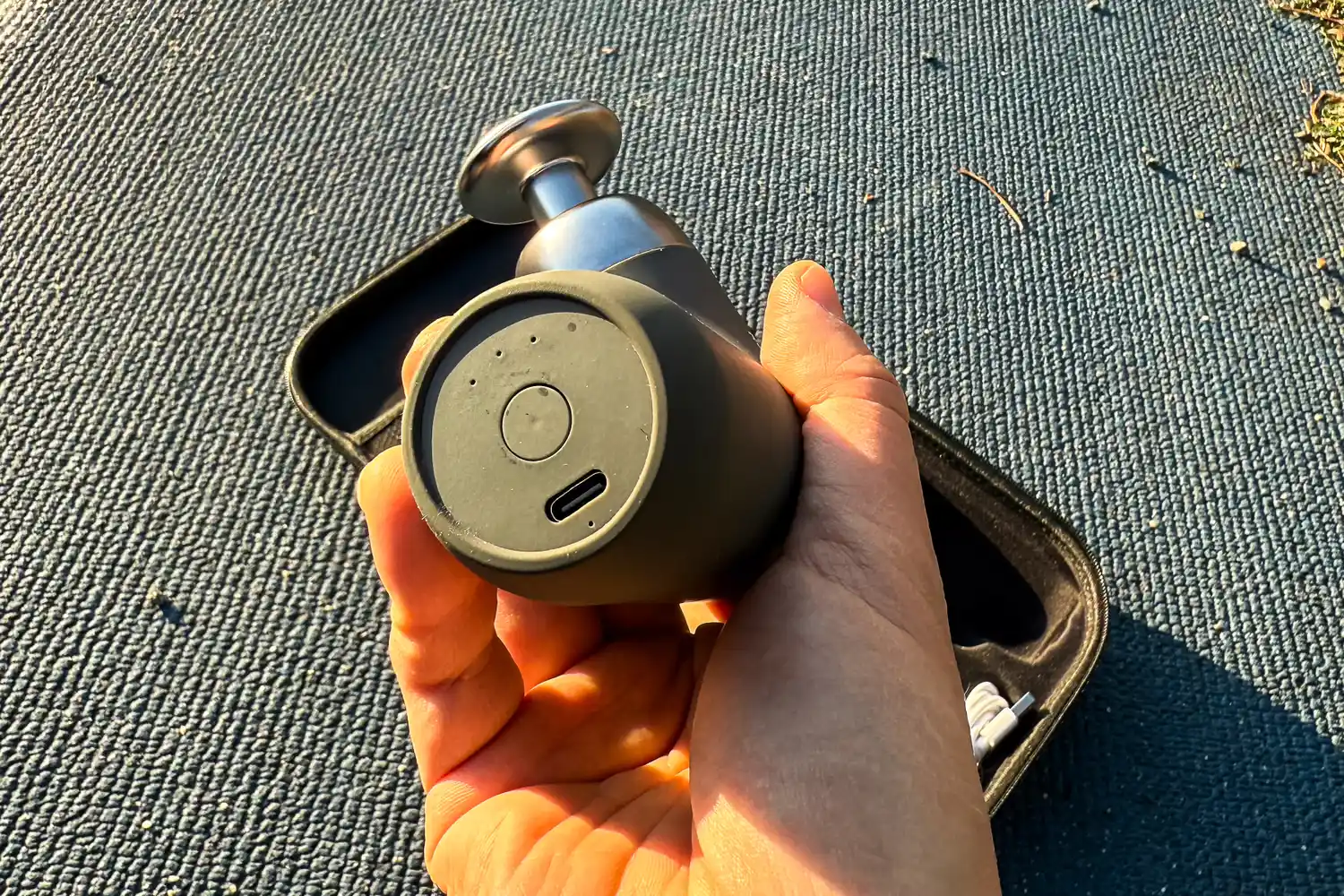 The charging port on the bottom of the Renpho Mini Thermal Massage Gun