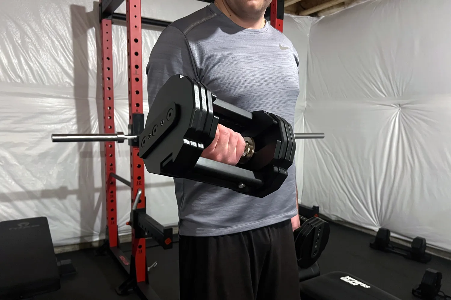 A person lifts up the REP Fitness REP x PÉPIN FAST Series Adjustable Dumbbell