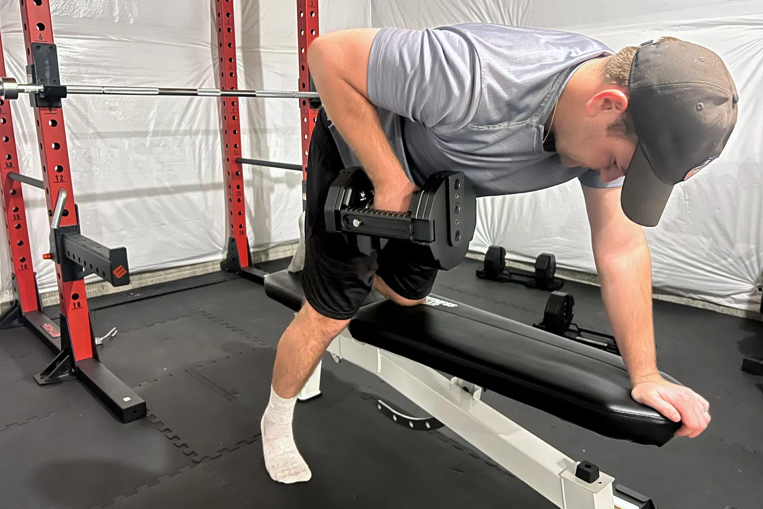 A person lifts the REP Fitness REP x PÉPIN FAST Series Adjustable Dumbbell