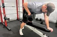 A person lifts the REP Fitness REP x PÉPIN FAST Series Adjustable Dumbbell