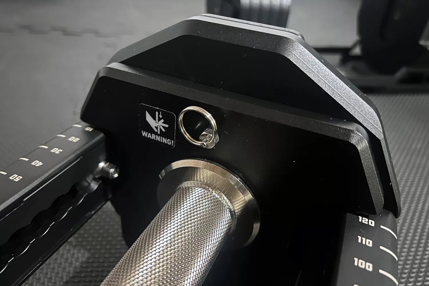 The warning sticker on the REP Fitness REP x PÉPIN FAST Series Adjustable Dumbbell