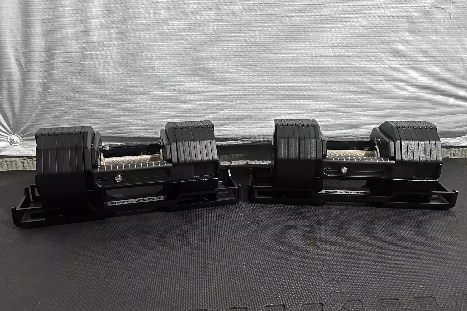 The REP Fitness REP x PÉPIN FAST Series Adjustable Dumbbell on an exercise mat