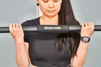 Person using the bar of the Gorilla Bow The Original Total Bundle