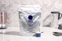 Ritual Essential Vegan Plant-Based Protein Powder on marble counter