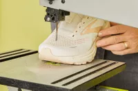 The Brooks Adrenaline GTS 23 being cut in half by a power saw