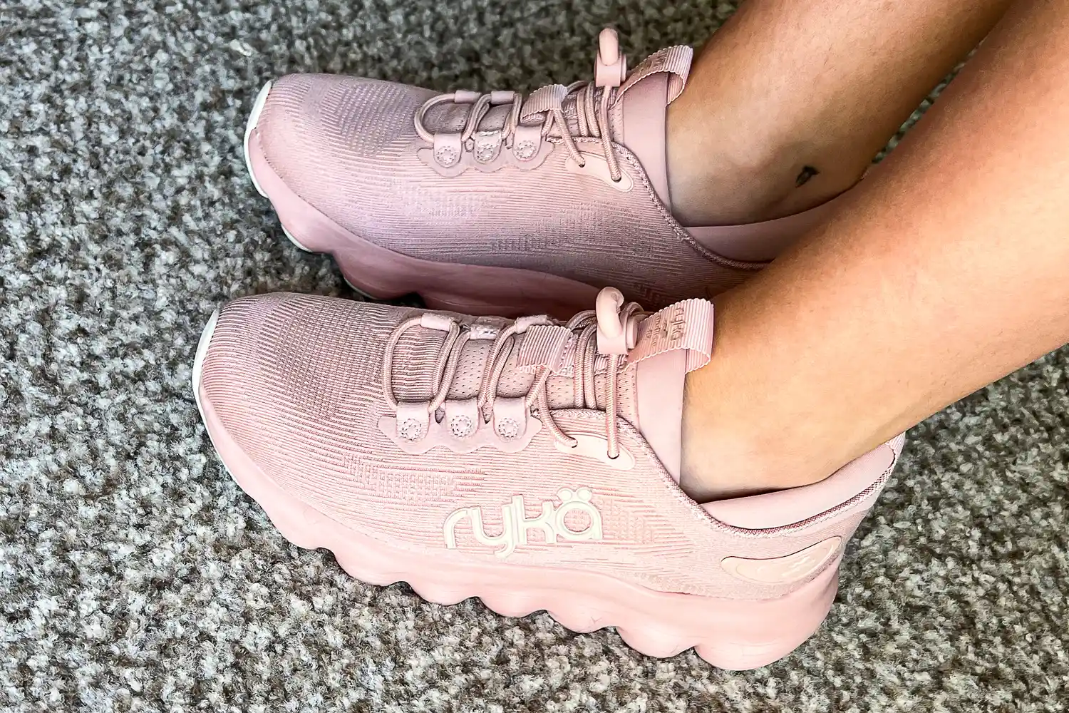 A side view of a person wearing the Rykä Women's Podflow EZ Walking Sneaker