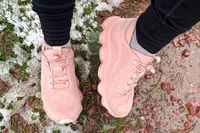 A person walks outside while wearing the Rykä Women's Podflow EZ Walking Sneaker