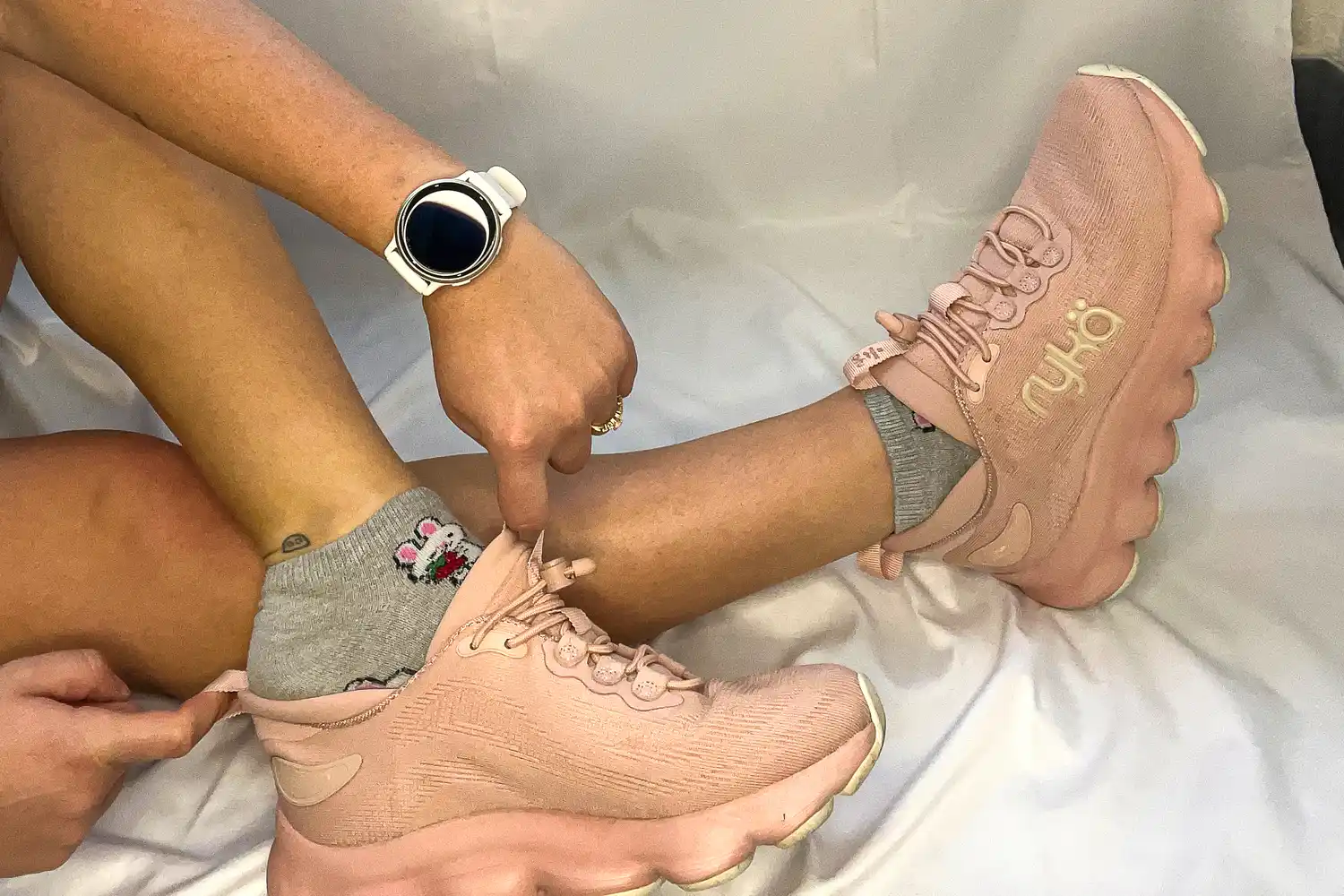 a person puts on the Rykä Women's Podflow EZ Walking Sneaker