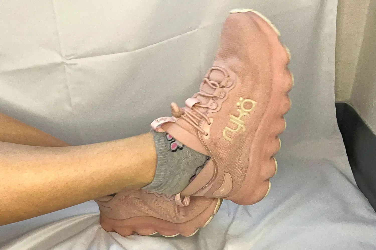 A person slides their foot out of the Rykä Women's Podflow EZ Walking Sneaker