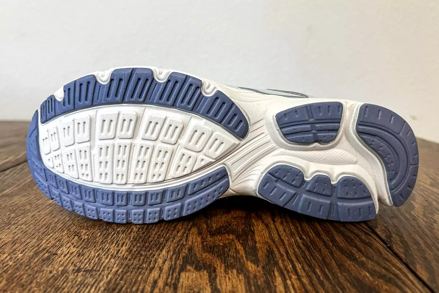 The bottom of a Ryka Women's Invoke Walking Shoe resting on a wooden surface