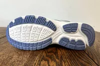 The bottom of a Ryka Women's Invoke Walking Shoe resting on a wooden surface