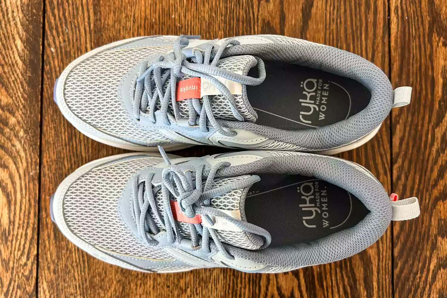 An overhead view of the Ryka Women's Invoke Walking Shoes on wood
