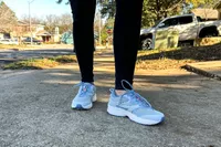 A person's legs posed while wearing the Ryka Women's Invoke Walking Shoes in grass
