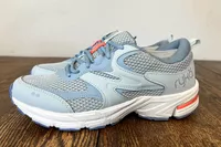 The Side view of the Ryka Women's Invoke Walking Shoes on wood