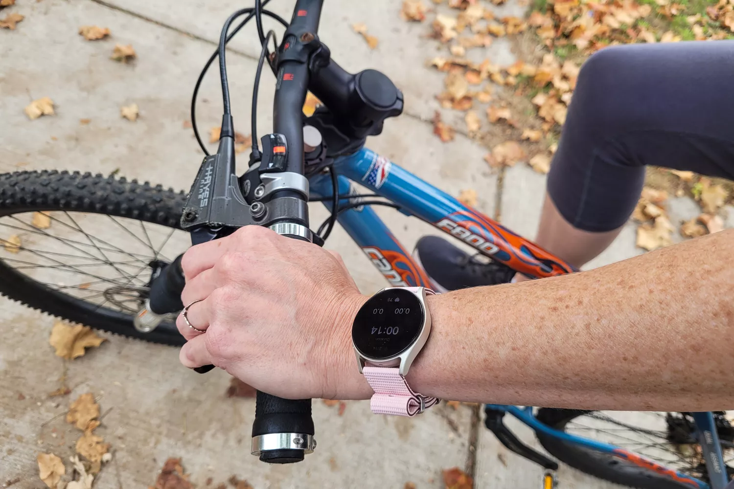 A person wears the Samsung Galaxy Watch7 while biking