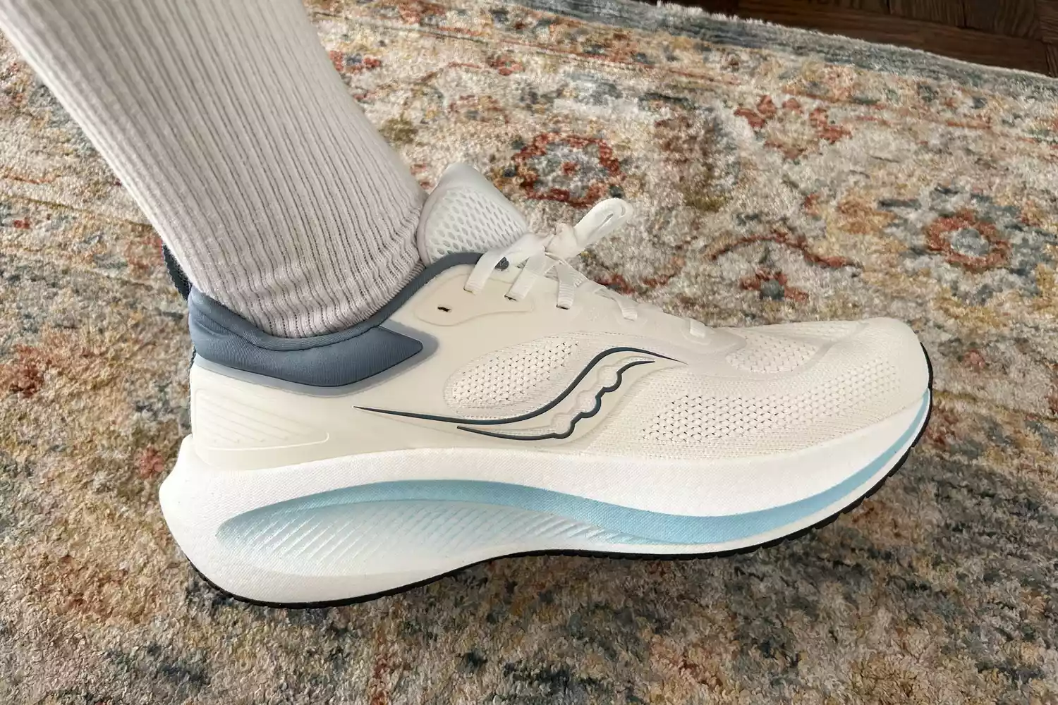 A person wears the Saucony Men's Surge 3 Everyday Shoe