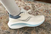 A person wears the Saucony Men's Surge 3 Everyday Shoe