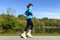 A person runs while wearing the Saucony Women's Echelon 10 Running Shoes