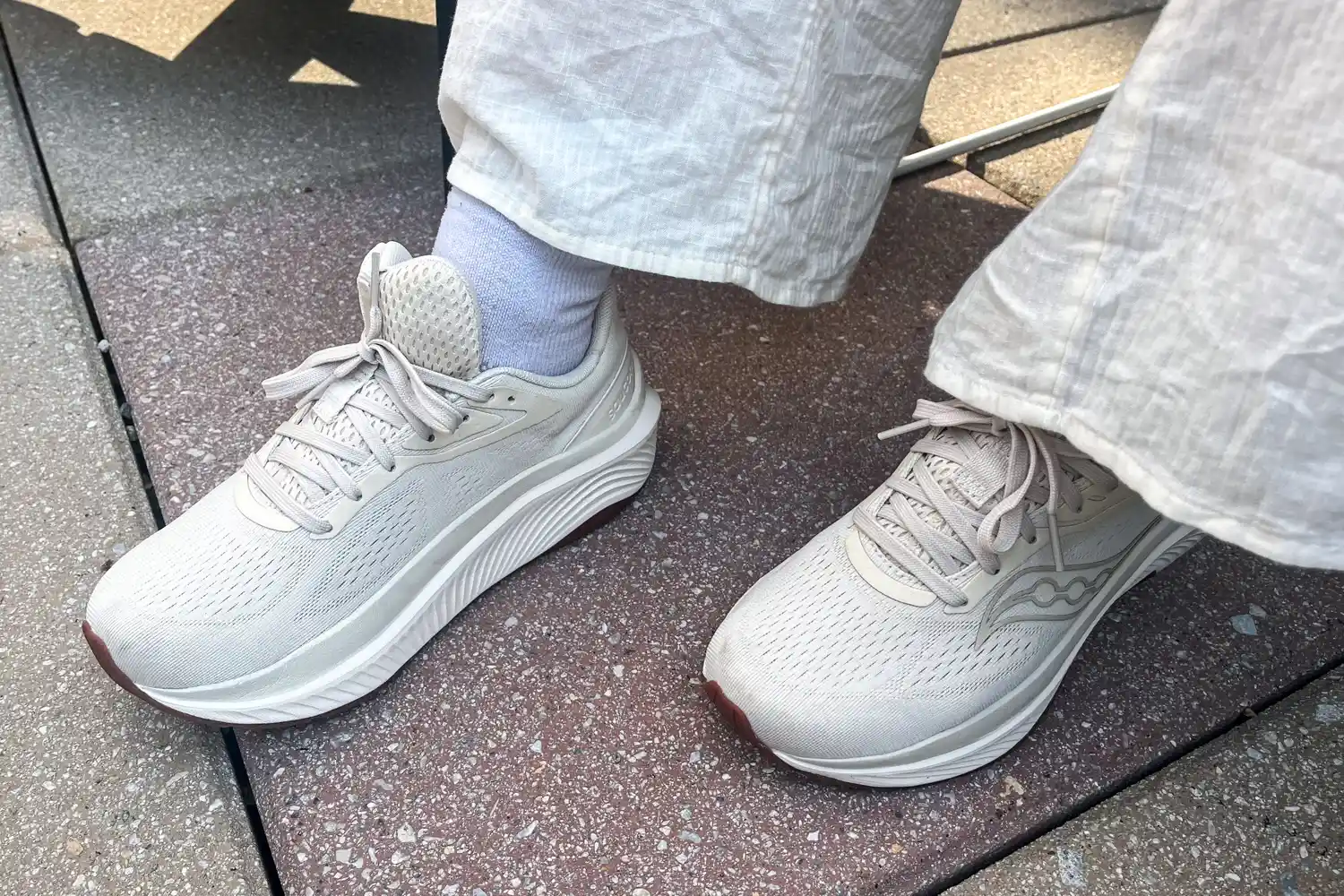 A person wears the Saucony Women's Echelon 10 Running Shoes while walking outside