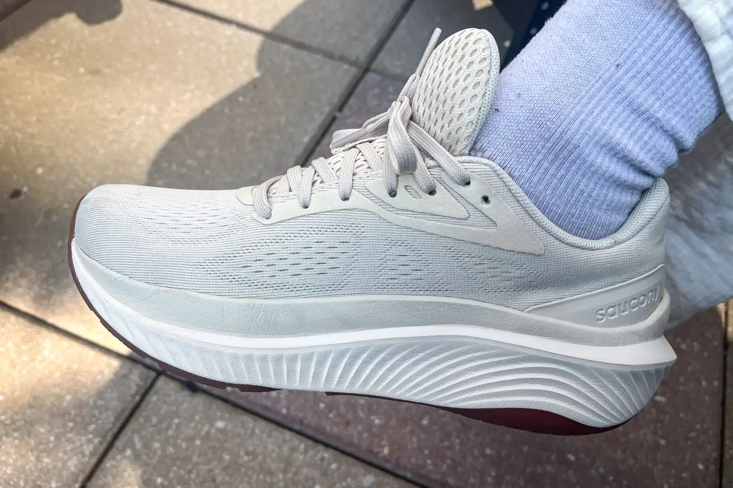 A side view of a person wearing the Saucony Women's Echelon 10 Running Shoes