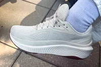 A side view of a person wearing the Saucony Women's Echelon 10 Running Shoes