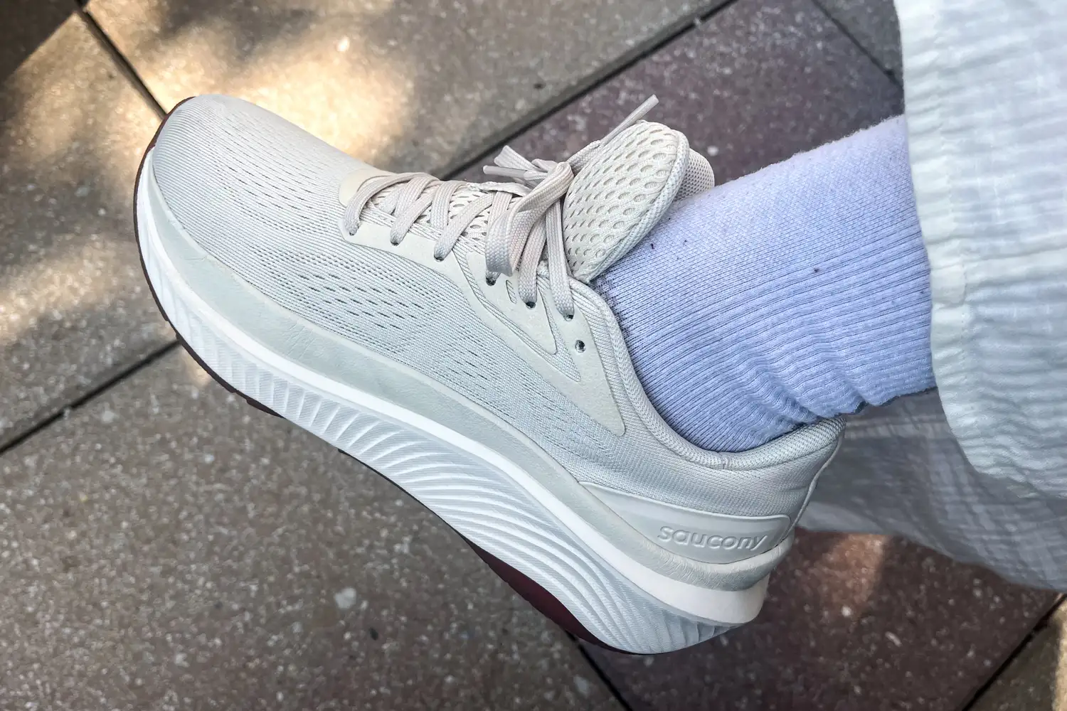 A side view of a person wearing the Saucony Women's Echelon 10 Running Shoe