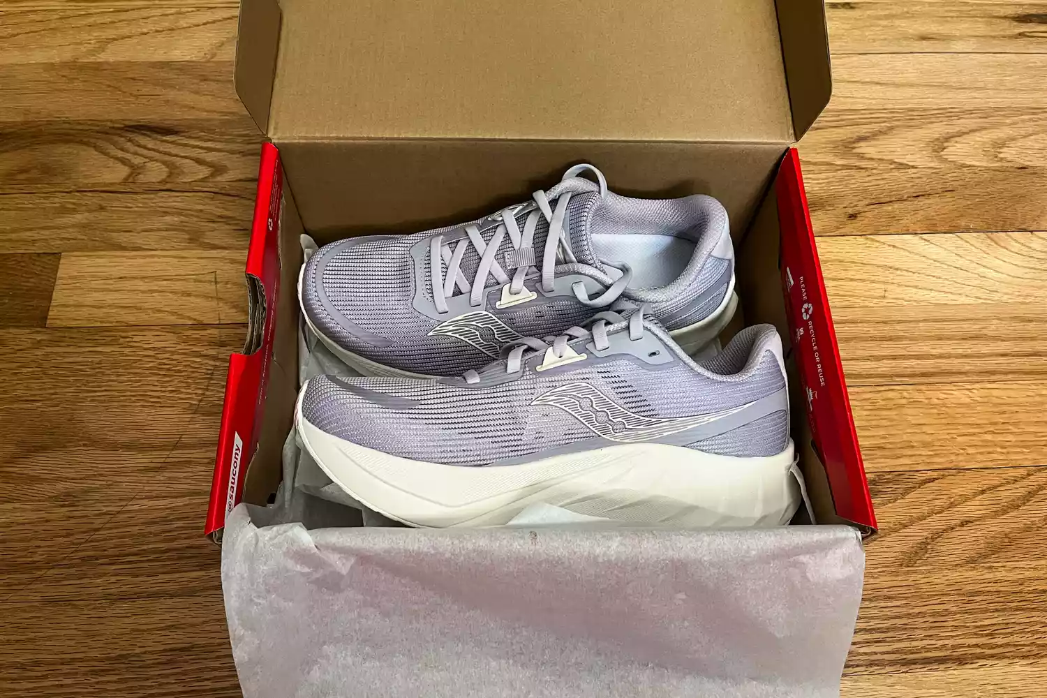 The Saucony Women's Tide 2 Walking Shoes in a shoebox