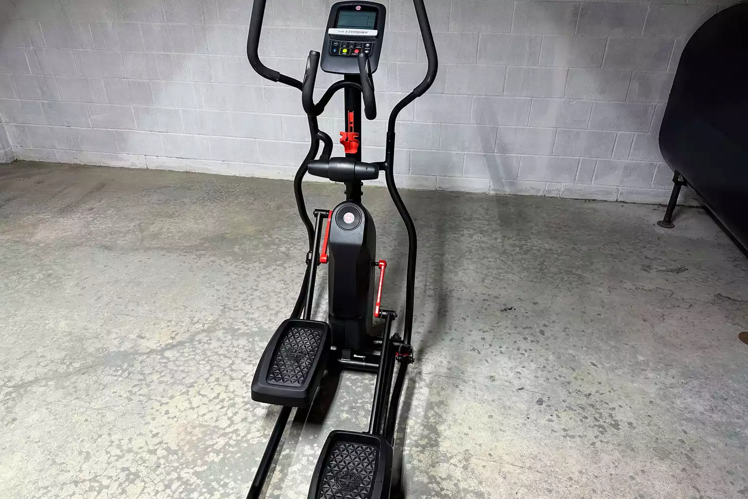 The Schwinn 411 Compact Elliptical Machine in a basement