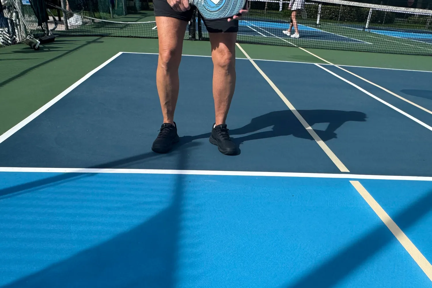 A person wearing the Selkirk Women's CourtStrike Pro Pickleball Shoes while playing pickleball