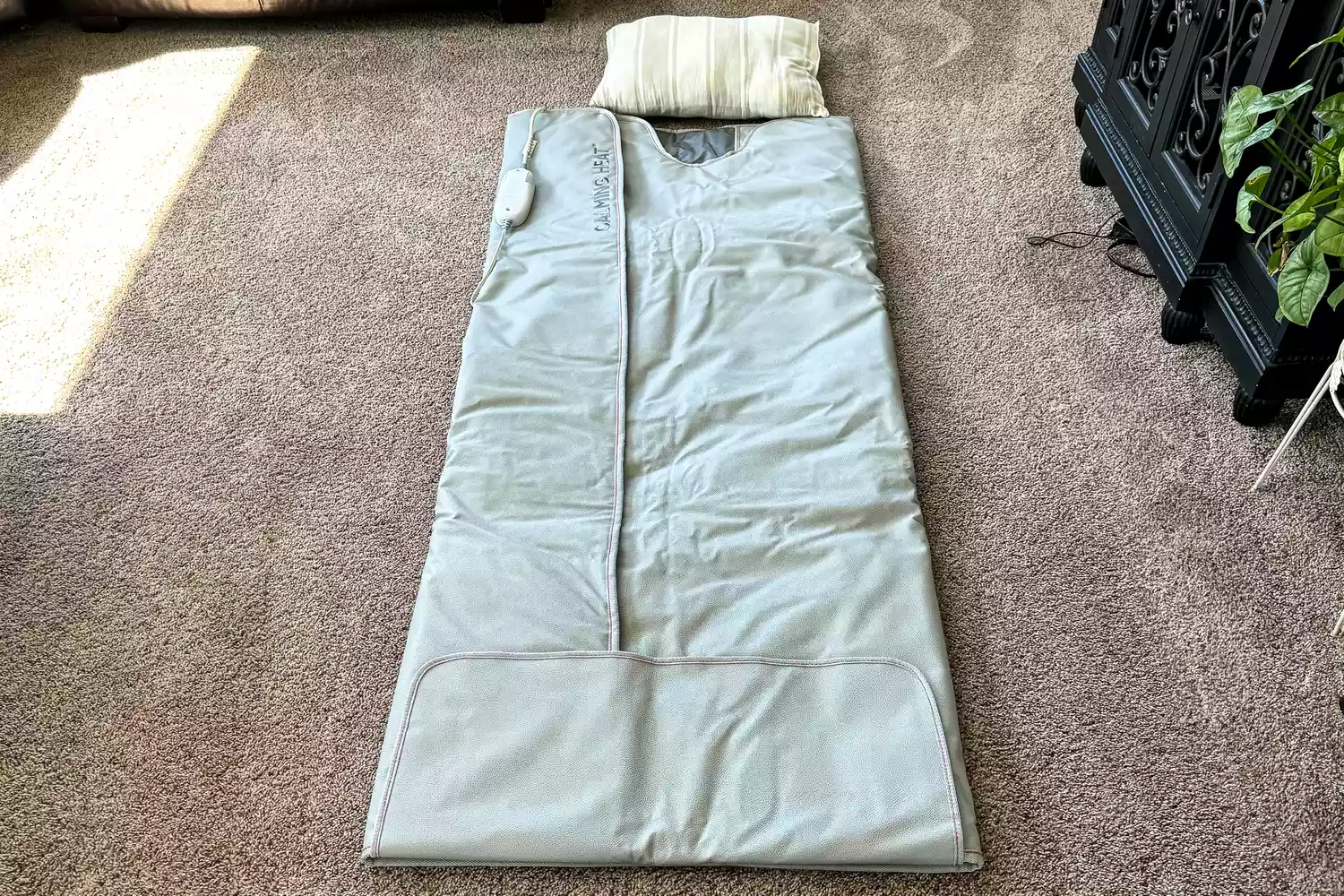 The Sharper Image Calming Heat Sauna Infrared Wrap on a carpet