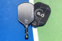The Six Zero Double Black Diamond Control Pickleball Paddle and cover on a court
