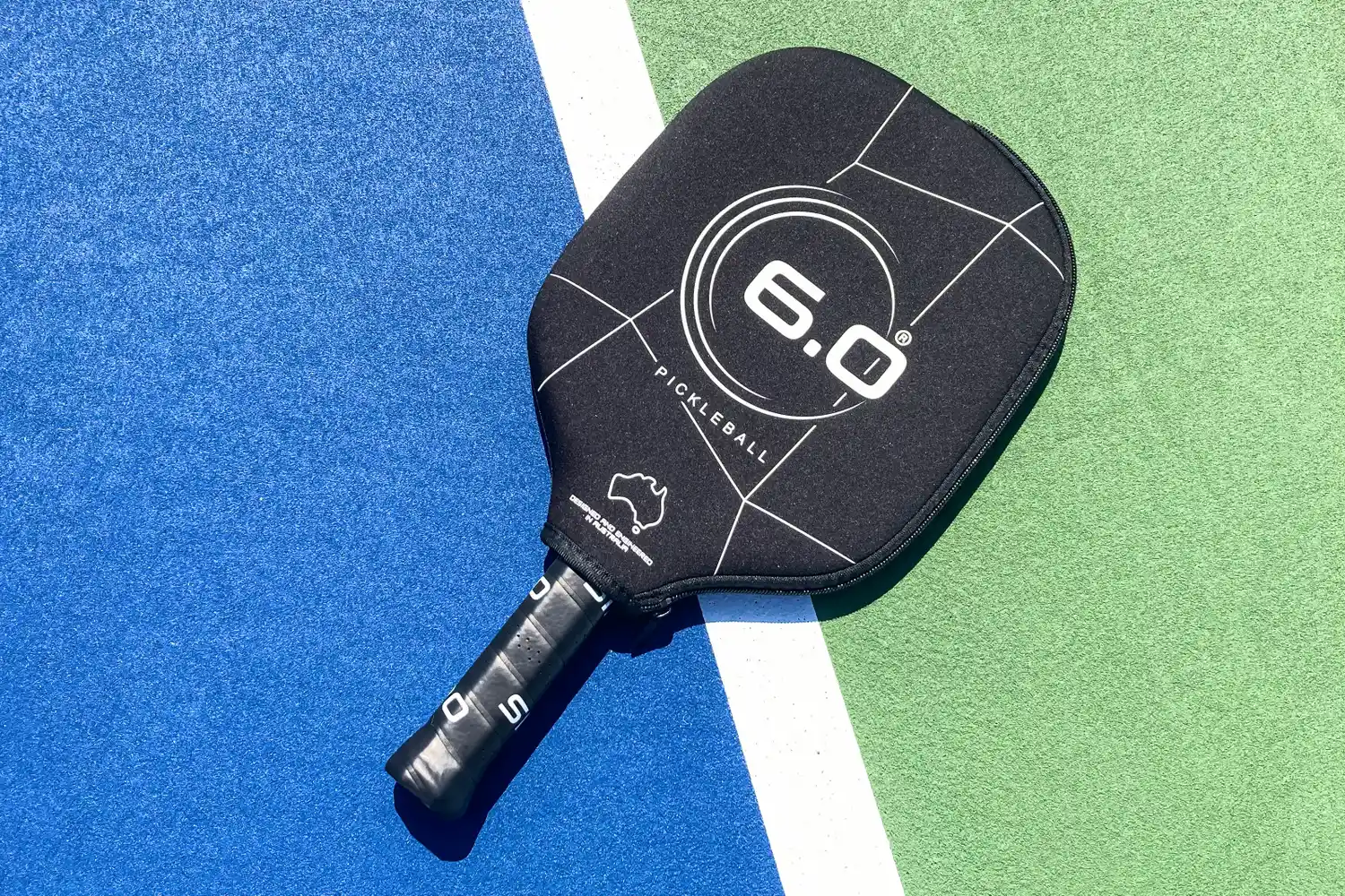 The Six Zero Double Black Diamond Control Pickleball Paddle with a cover on