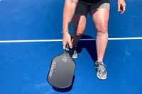 A person plays pickleball with the Six Zero Double Black Diamond Control Pickleball Paddle