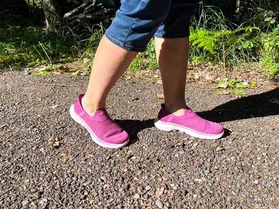 A person walks outside while wearing the Skechers Slip-Ins Go Walk 7 Springtime Walking Shoes