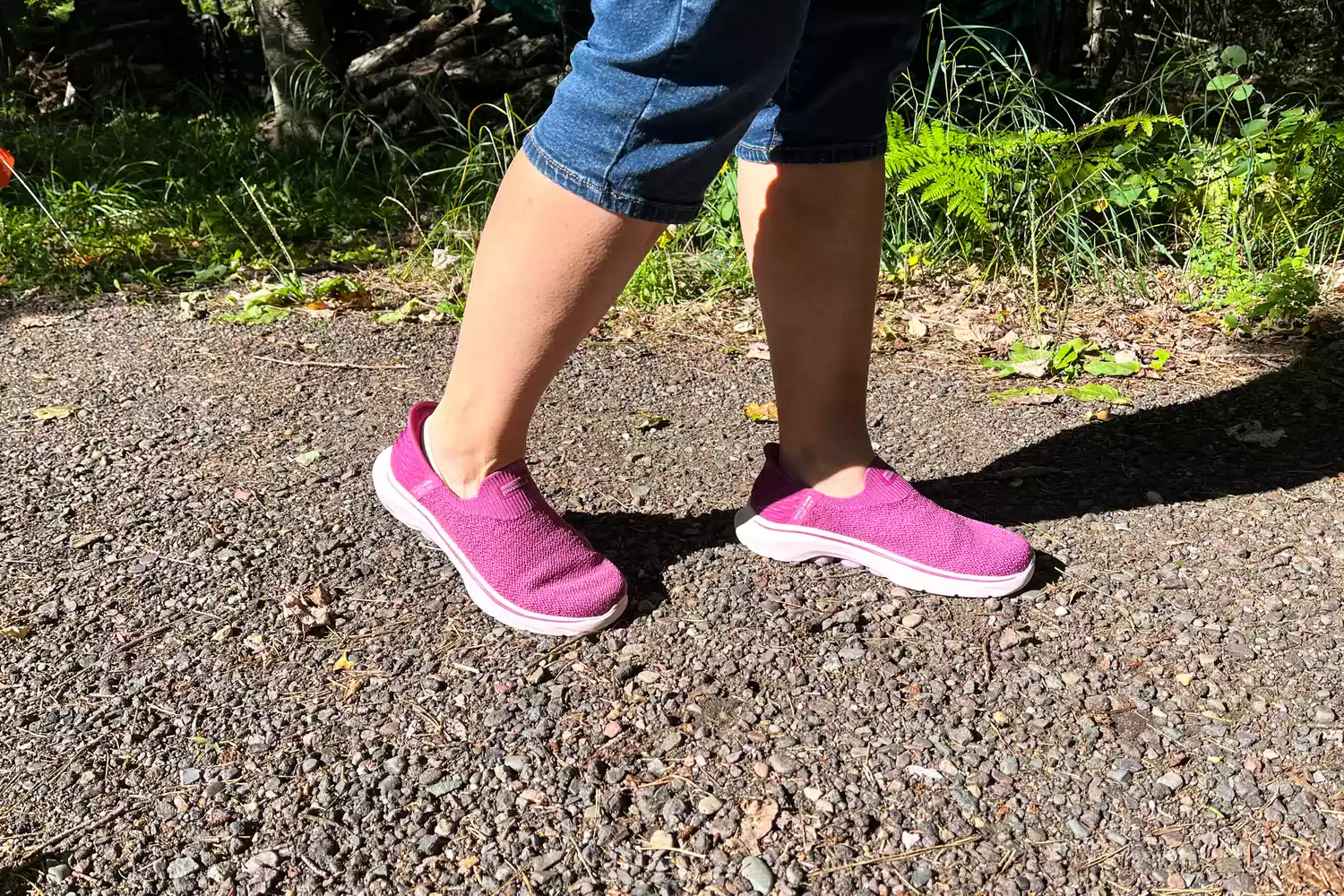 A person walks outside while wearing the Skechers Slip-Ins Go Walk 7 Springtime Walking Shoes