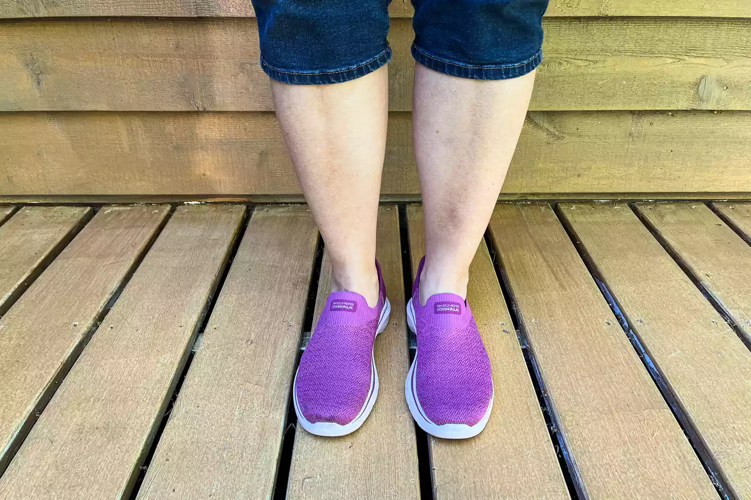 A person wears the Skechers Slip-Ins Go Walk 7 Springtime Walking Shoes outside