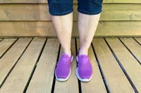 A person wears the Skechers Slip-Ins Go Walk 7 Springtime Walking Shoes outside