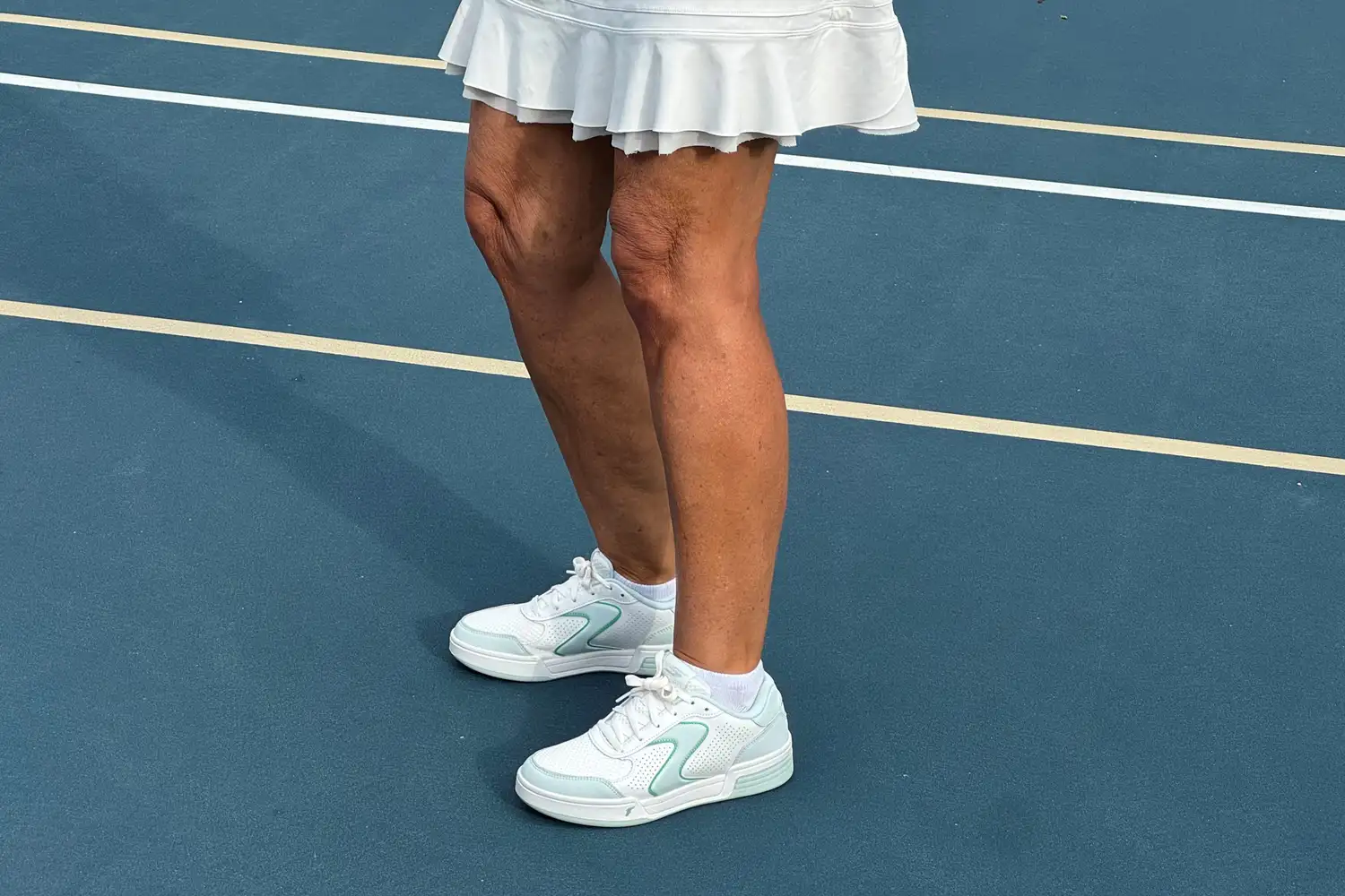 A person wears the Skechers Women's Viper Court Classic Pickleball Shoes while playing pickleball