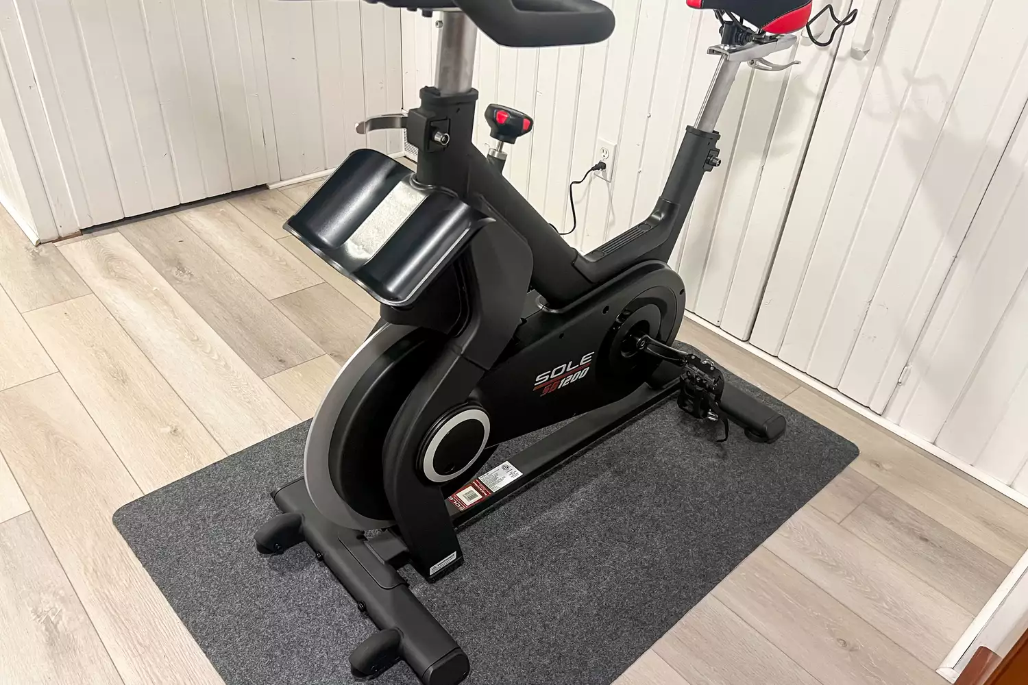 The SOLE SB1200 Exercise Bike on a black mat