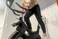 A person rides the SOLE SB1200 Exercise Bike