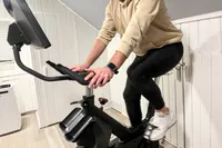 A person exercises on the SOLE SB1200 Exercise Bike
