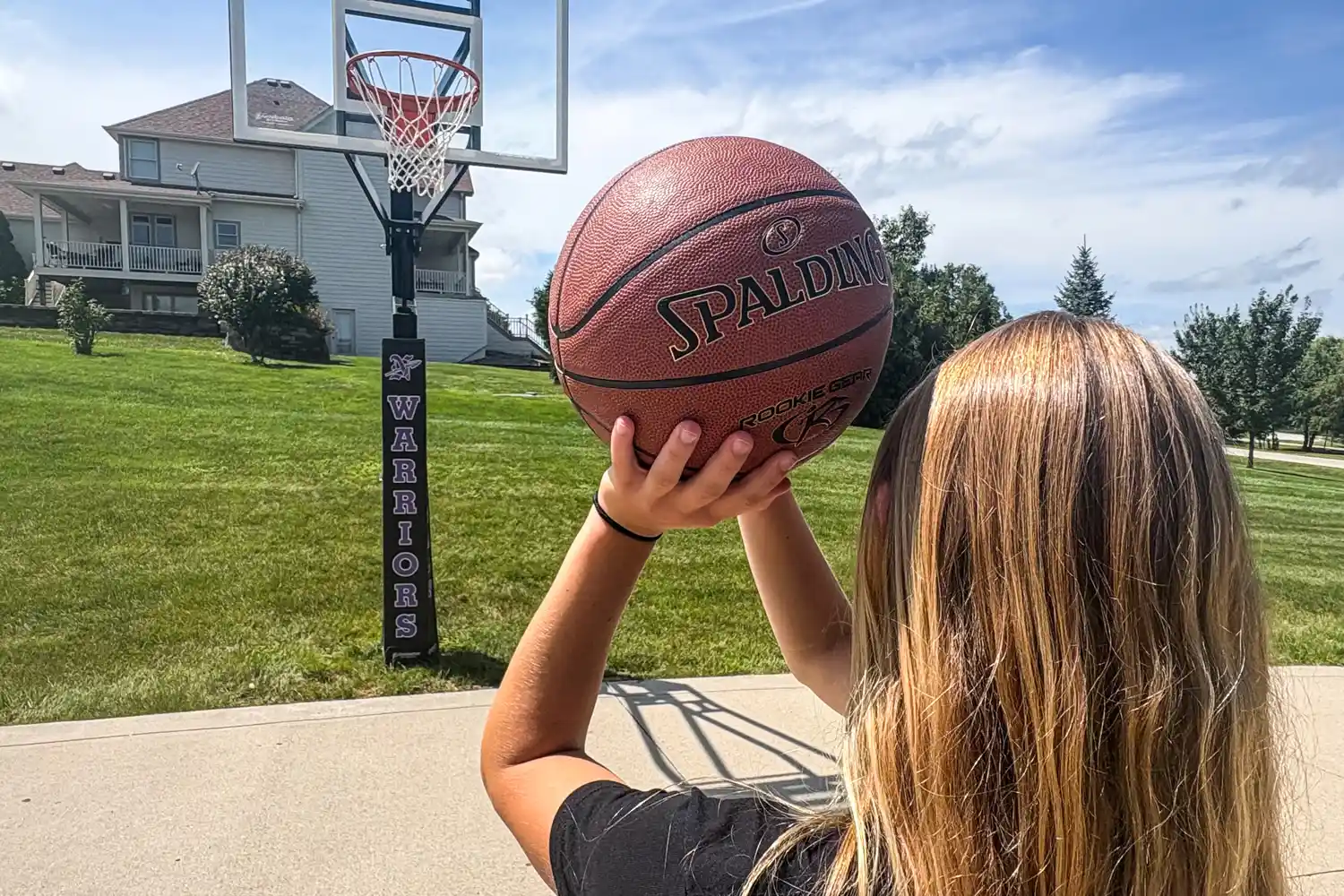 A person shoots the Spalding Rookie Gear Youth Indoor-Outdoor Basketball